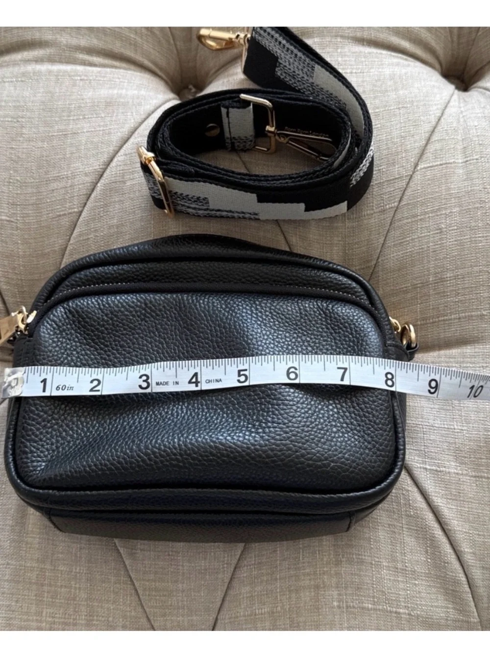 Compact Black Pebble Crossbody with Patterned Strap